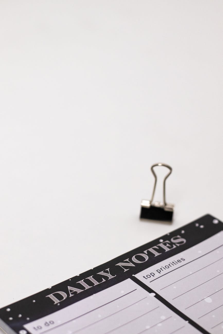 a binder clip and a daily notes planner