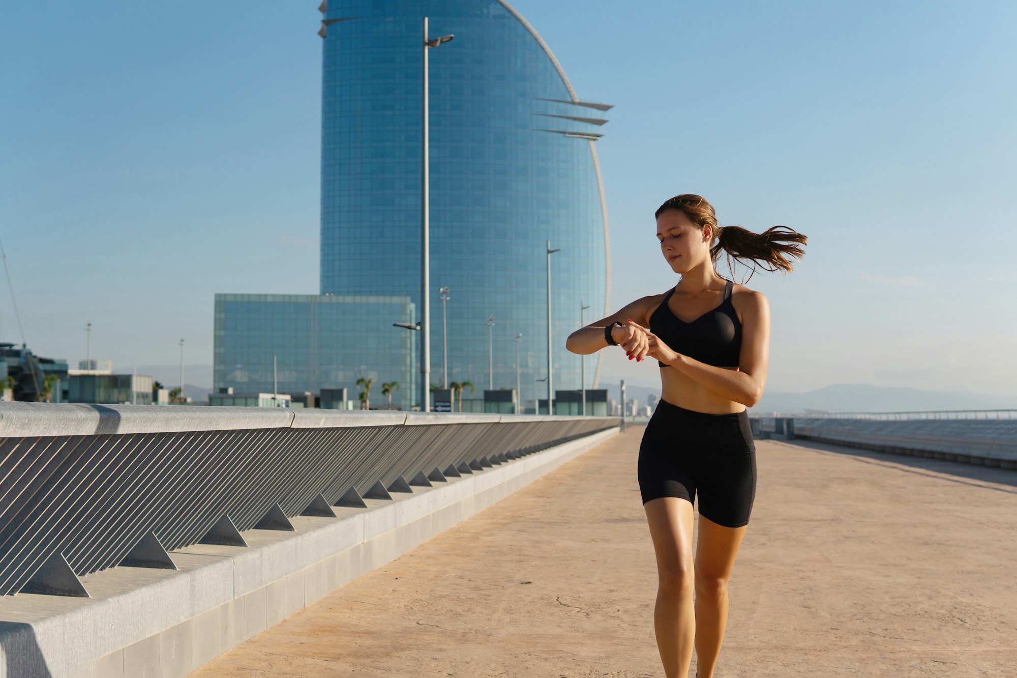 Young jogger using smart watch